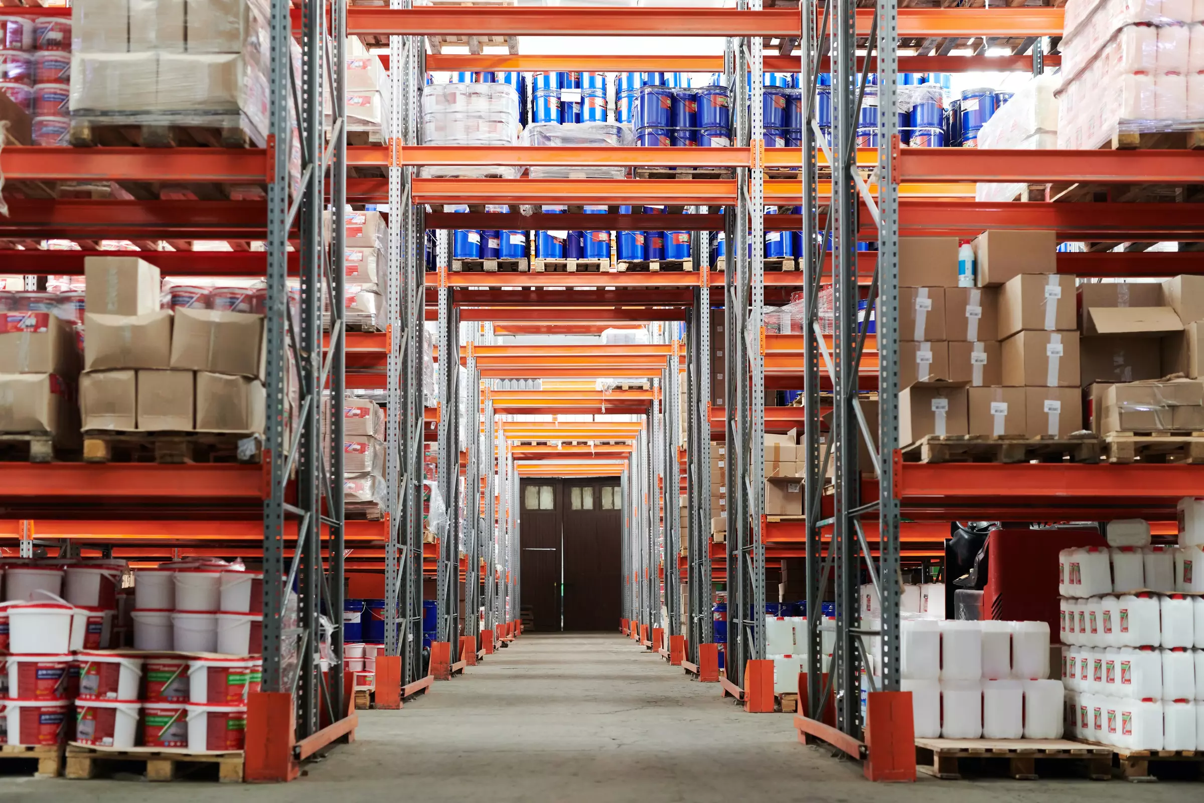 Warehouse dock doors with pallets being transferred between trailers.