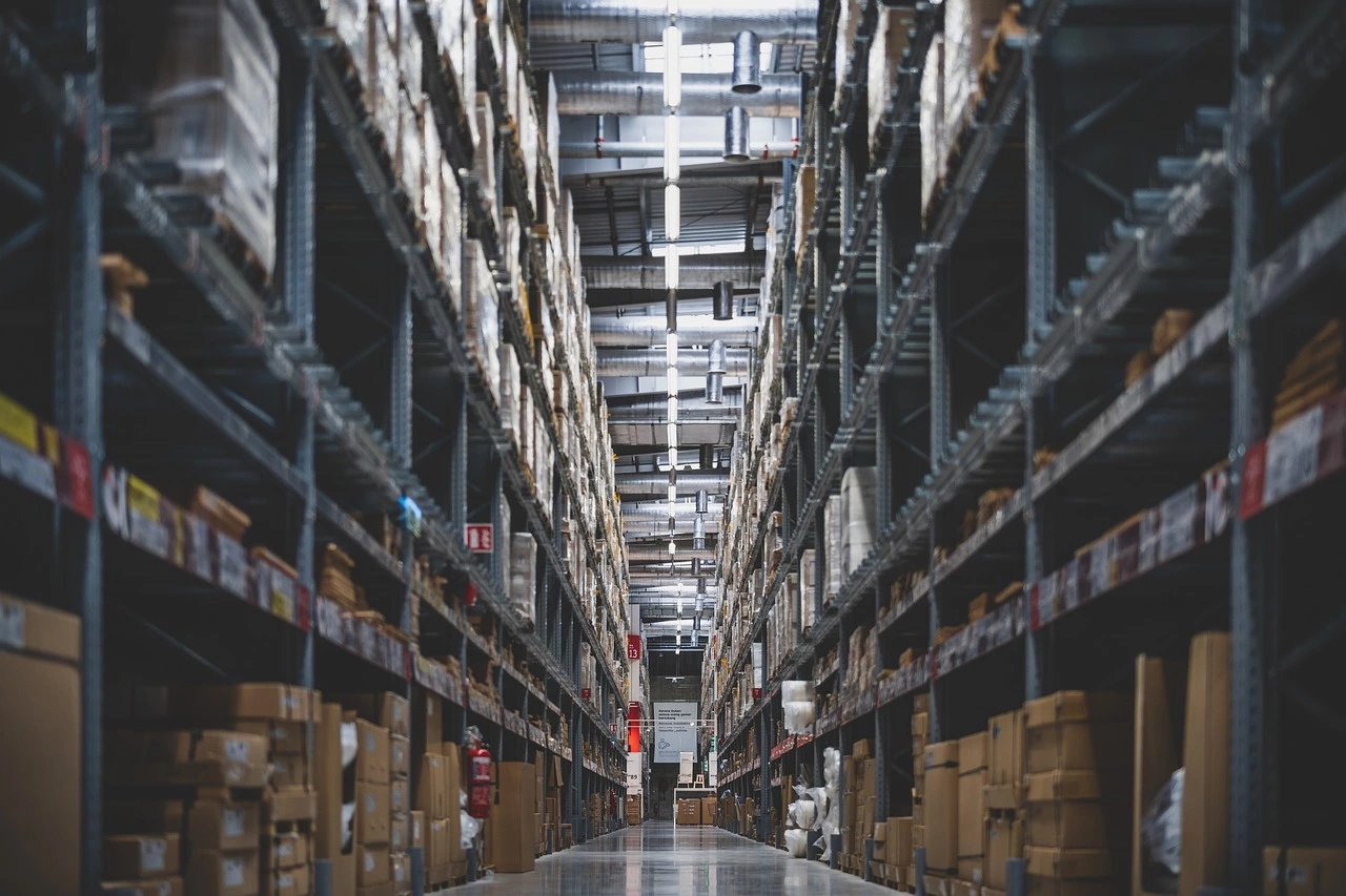 A well-organized warehouse aisle filled with neatly stacked boxes and shelves.